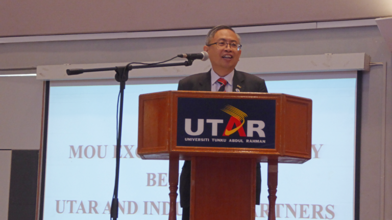 UTAR President Professor Dr Ewe Hong Tat on stage launching a UTAR-Finexus collaboration