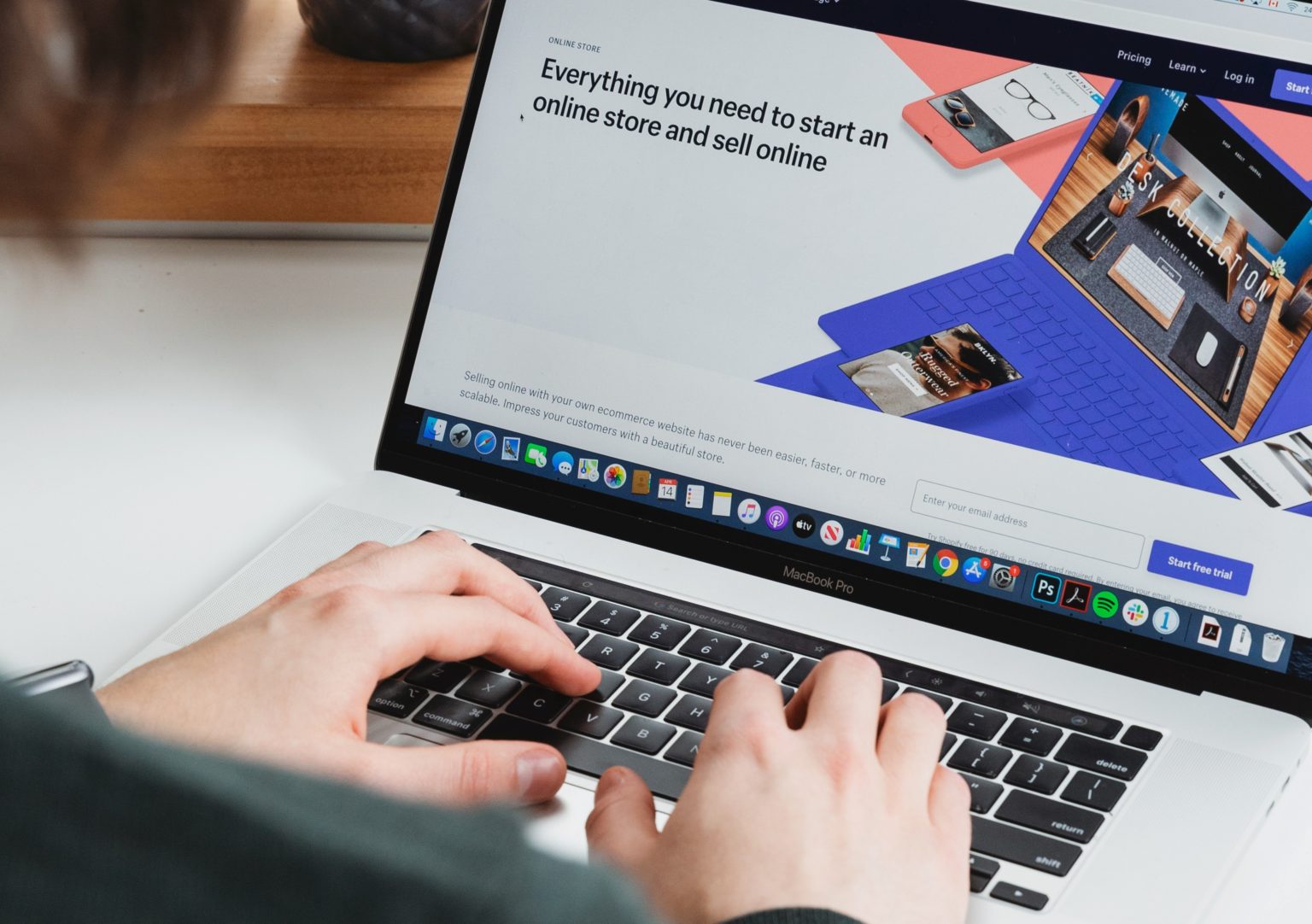 A person typing on the keyboard of a laptop